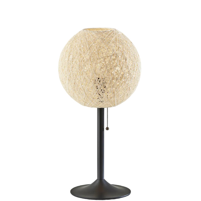A modern table lamp with a spherical, woven beige shade and a dark metal stem on a solid white background.