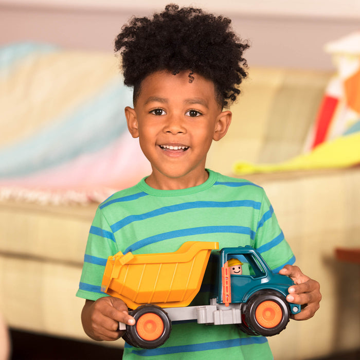 A toy dump truck with a little driver for kids and toddlers.