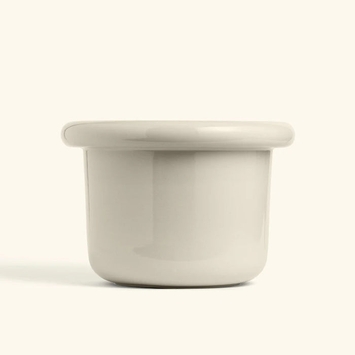 Glossy polar white ceramic planter with a wide lip and rounded edges, perfect for modern home decor.
