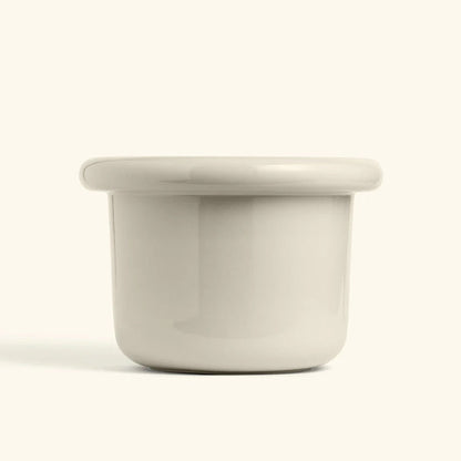 Glossy polar white ceramic planter with a wide lip and rounded edges, perfect for modern home decor.
