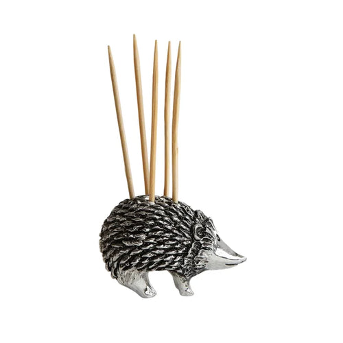 Silver hedgehog-shaped toothpick holder with wooden toothpicks on a white background
