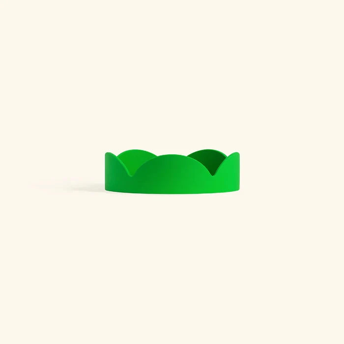 Bright green petal-shaped drip tray with a smooth matte finish for home decor or plant protection.