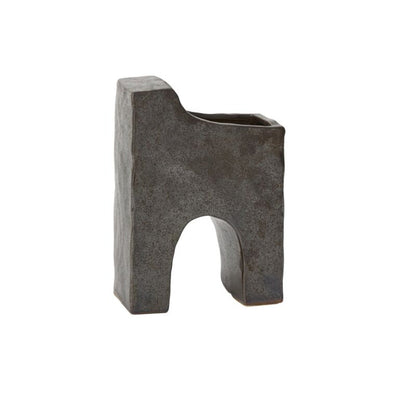 Dark grey sculptural bookend with a textured surface and an arch-shaped cutout on the bottom side