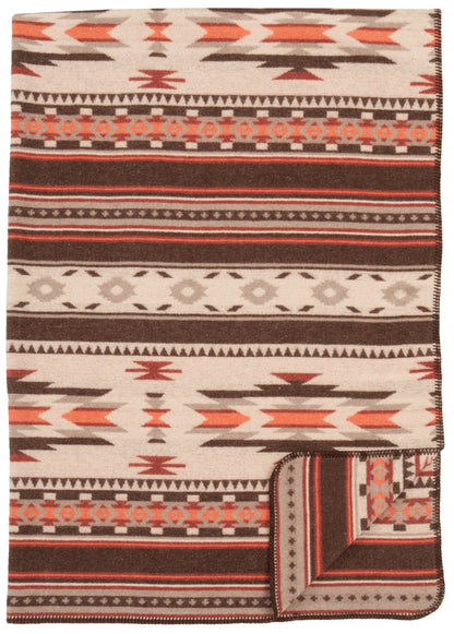 Soft wool blanket with geometric tribal patterns in brown, beige, and rust tones, folded at the corner.